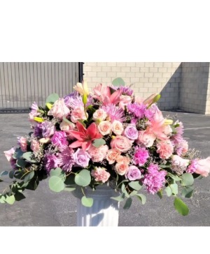 Pinks and lavenders casket arrangement  Funeral 