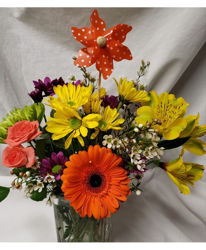 Pinwheel and Petals! Small bright assorted  (E) Flowers arranged in a vase with a pinwheel pick included in price. (SOME flowers and colors may change due to stock)