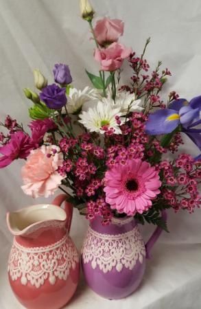 Pitcher with Lace Bouquet...seasonal flowers  (E) arranged in ceramic pitcher. (Pitcher may be lavender or pink)