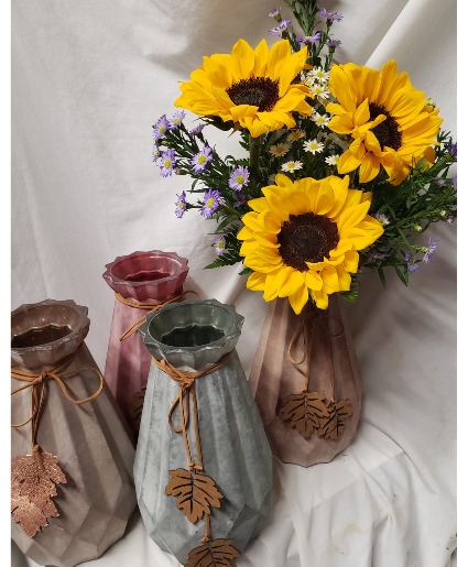 3 SUNFLOWERS  IN TALL  CERAMIC VASE (F) with a DANGLING LEAF WITH SEASONAL FILLER...VASE Comes in different colors POPULAR LIMITED SUPPLY