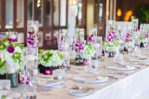 purple orchids in tall vase 