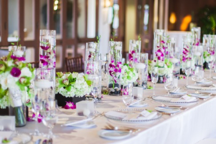 purple orchids in tall vase 