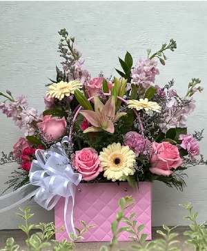 PINK BAG LADY  ARRANGEMENT OF ROSES, STOCK, LILIES, AND MULTIPLE OTHER FLOWES TO FILL THEIR DAY WITH BLOOMS OF HAPPINESS.