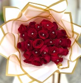 Bejeweled Red roses wrapped in pink paper  