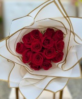 Wrapped red roses in white paper  