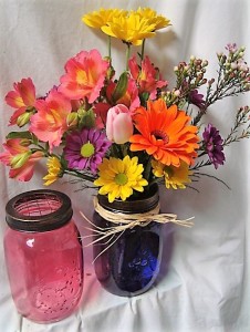 "RUSH OF COLOR".(E)..BRIGHT FLOWERS   ARRANGED IN A BRIGHT MASON JAR WITH RAFFIA RIBBON!!