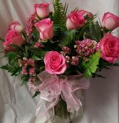 DOZEN PINK ROSES ARRANGED (R) with seasonal filler or baby's breath...Wax flower is seasonal