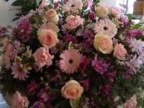 ETERNAL PEACE Half Casket Spray of pinks,purples and lavenders. Roses, Gerbera Daisies, daisies,carnations and more.
