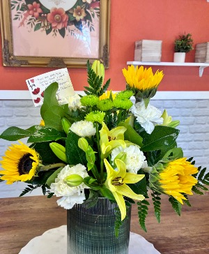 Sunflower explosion with Lilies  Tall Clear ribbed vase with aspidistra leaf 