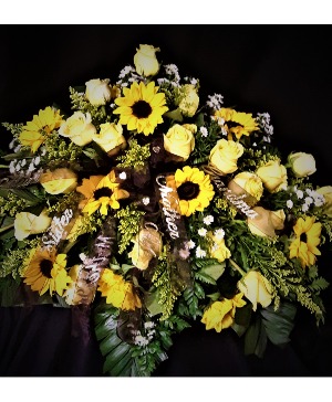 Sunny display of peace and remembrance casket spray