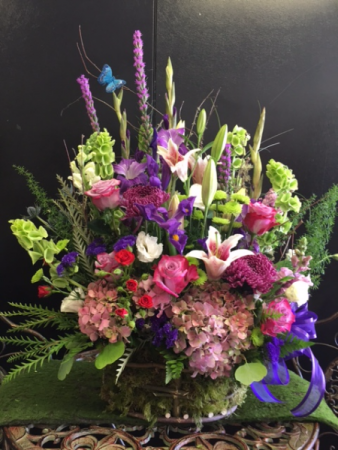 Sympathy basket tribute Nice mix of seasonal flowers arranged in a basket