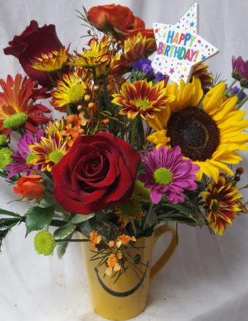 Happy face birthday theme mug arrangement (B) With Fall seasonal flowers and Happy Birthday Pic.