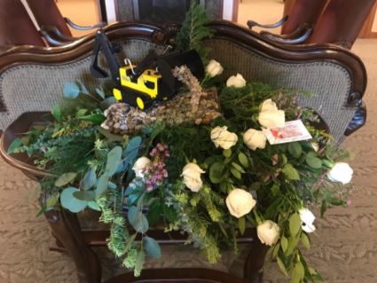 THEME EXPRESSIONS  CUSTOM BACKHOE ROCK FLORAL ARRANGEMENT 