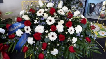 Touch of blue Red roses, white gerbera daisies, white carnations Monte cassino blue delphinium white roses in Jamestown, IN | Garden Gate Gift & Flower Shop
