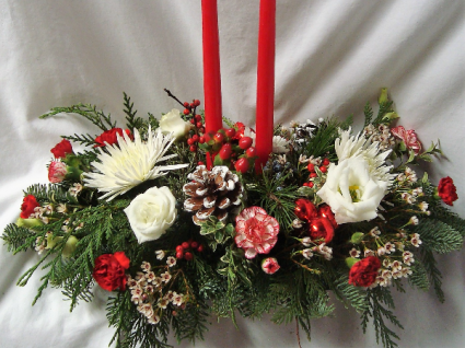 CHRISTMAS CENTERPIECE WITH (H) 2 candles red or white and RED AND WHITE FLOWERS, PINE CONES, CHRISTMAS GREENS, ETC.