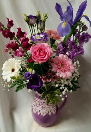 Ceramic pitcher with Lace detail filled with (E) Seasonal flowers!