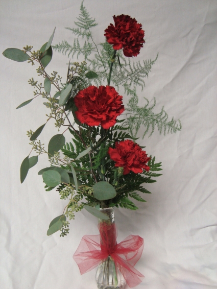 Three Carnations in a vase. (E) Color may be substituted.