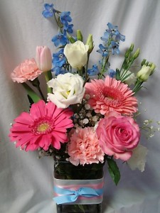 'WHITE AND BLUE COLORS WITH A WHITE ROSE FOR THE SORORITY FLOWER! ALL ARRANGED IN A CUTE RECTANGULAR VASE WITH PINK AND BLUE RIBBON DETAIL! THIS IS JUST A SAMPLE OF WHAT THEY LOOK LIKE