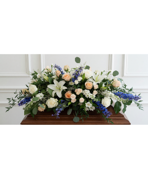 White, peach, and blue Casket spray