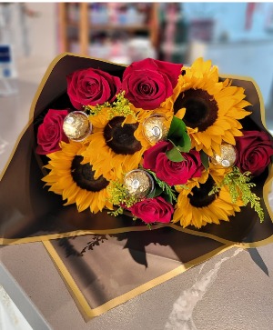 Wrapped bouquet roses and sunflowers  