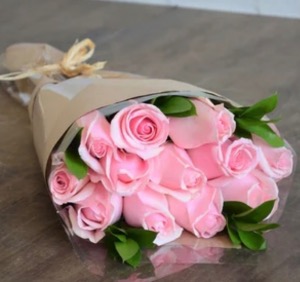 Wrapped pink roses with greens  Hand tied with greens